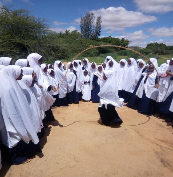 Girls playing with ropes at the school compound during break time. Girls playing with ropes at the school compound during break time.